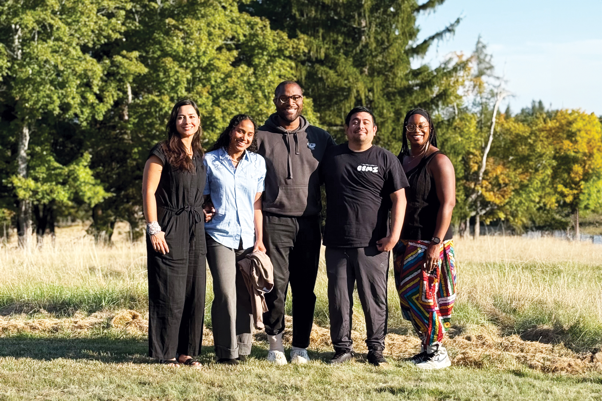 A photo of the five recipients of the Sandbox Fellowship, standing in a field.