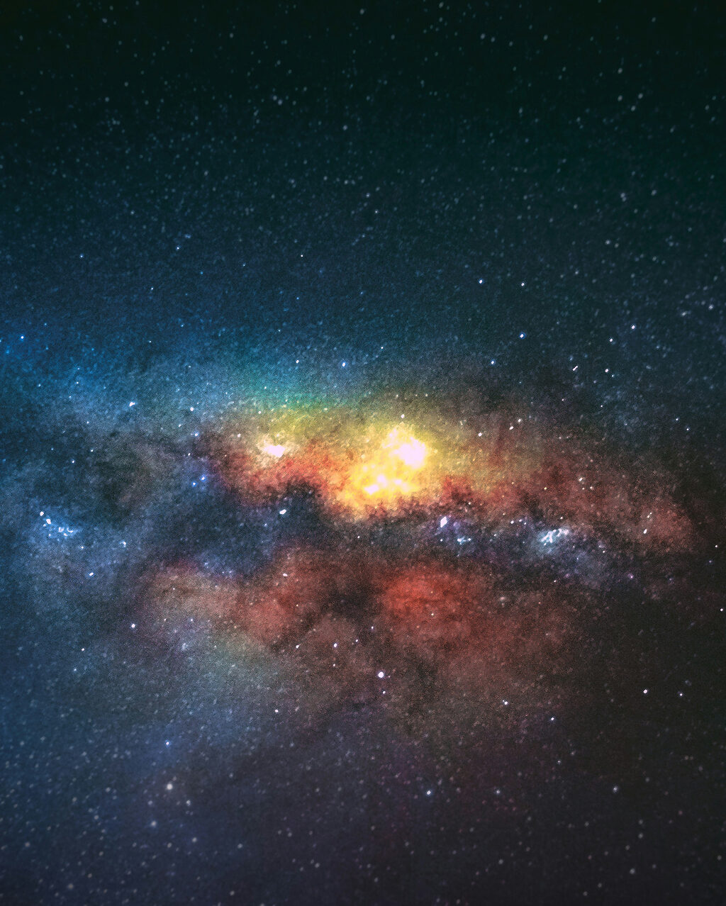 Bright, colorful section of the Milky Way galaxy with stars, glowing dust clouds, and nebulae against a dark night sky.