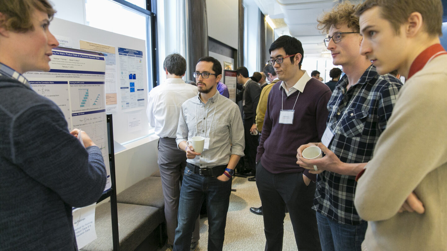 Five people standing around a presentation board