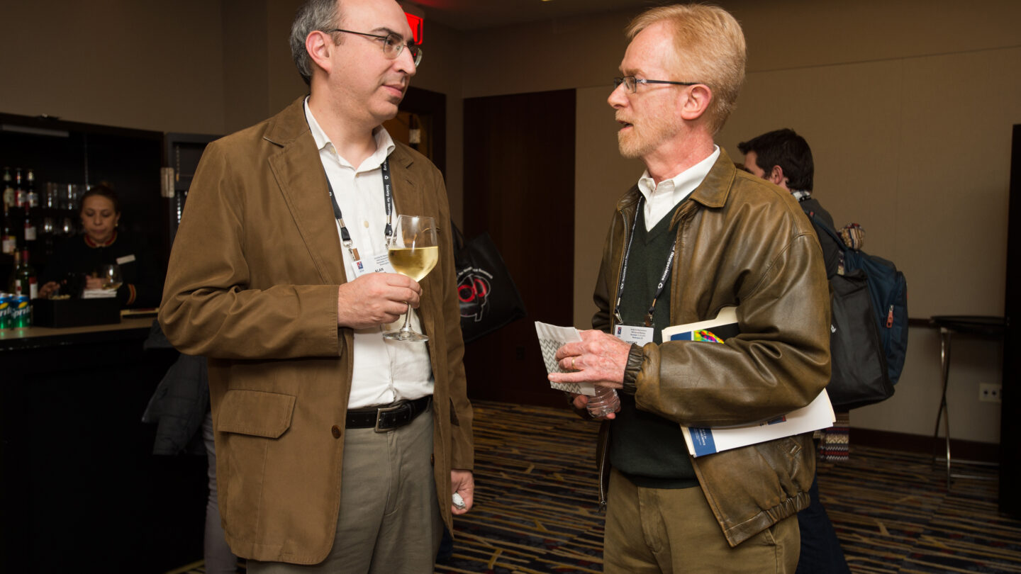 Two men standing and talking