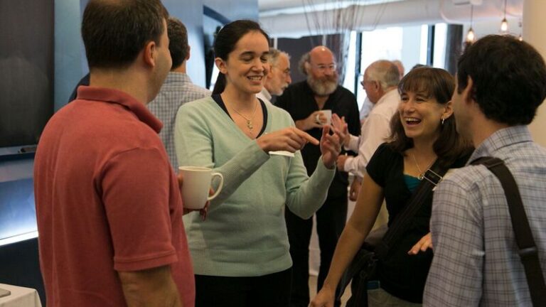 Group of four people standing and talking