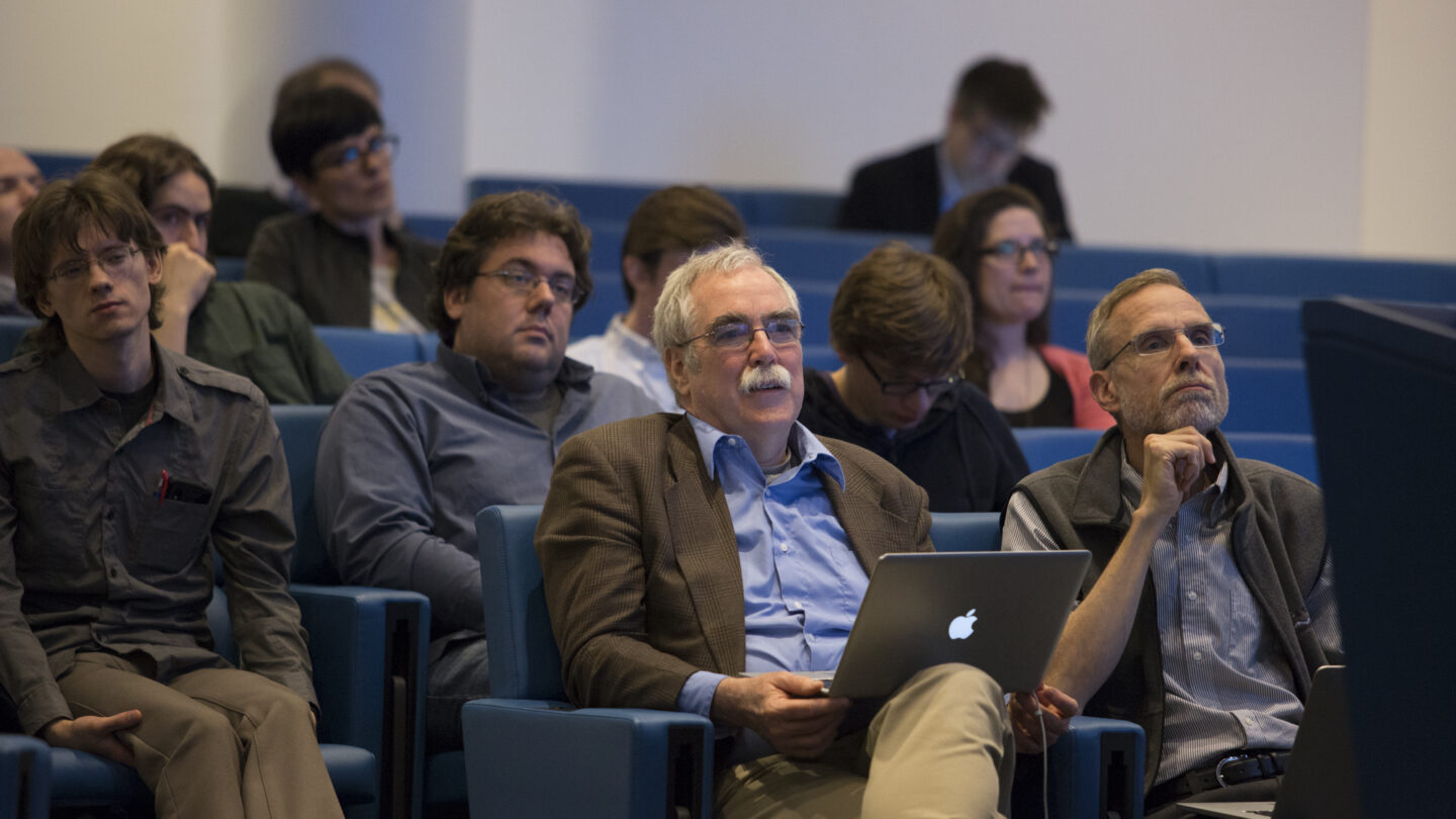 12 people sitting in a lecture hall and looking up