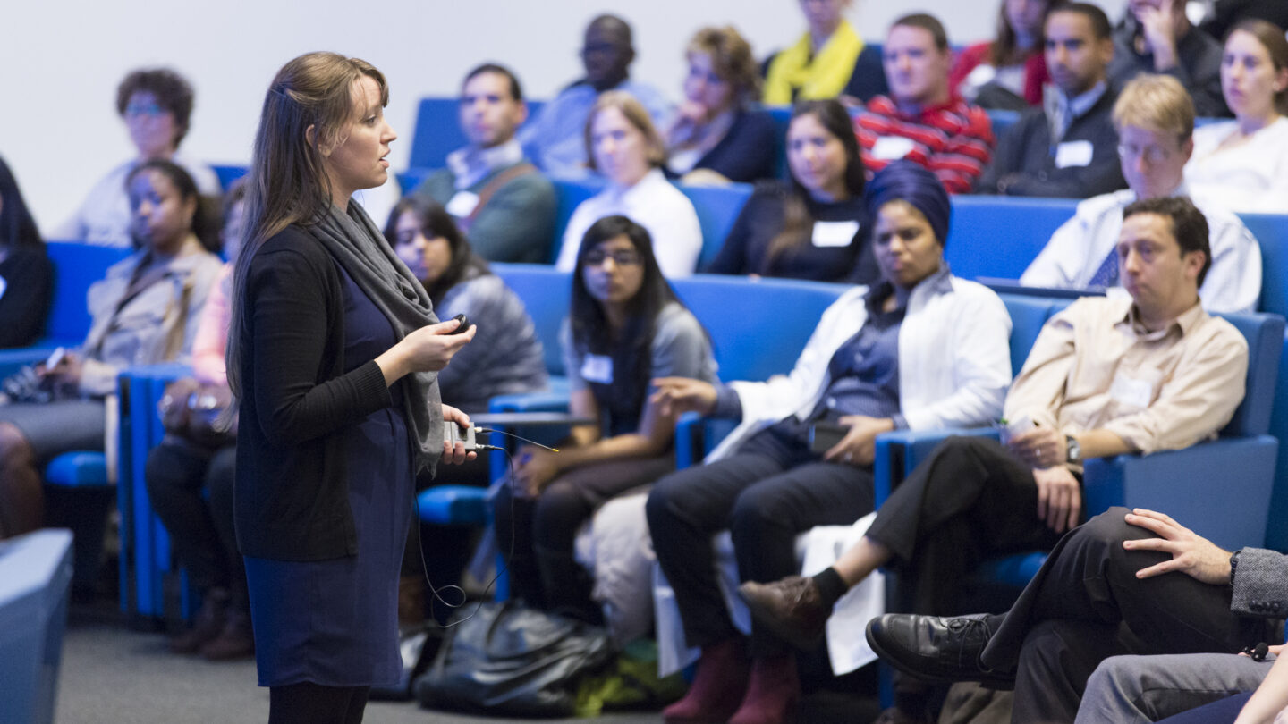 Woman standing in front of a lecture hall