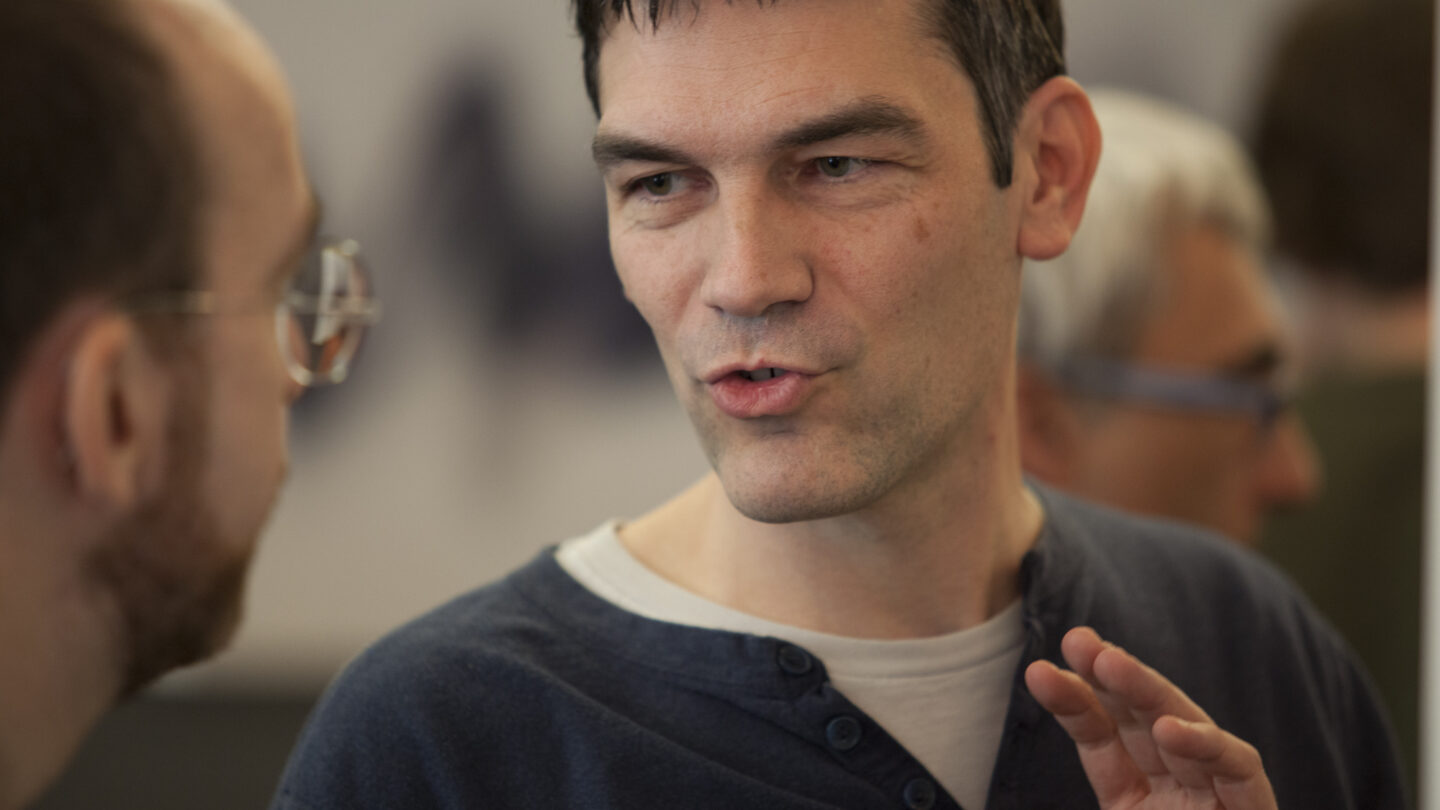 Man talking to someone to the right