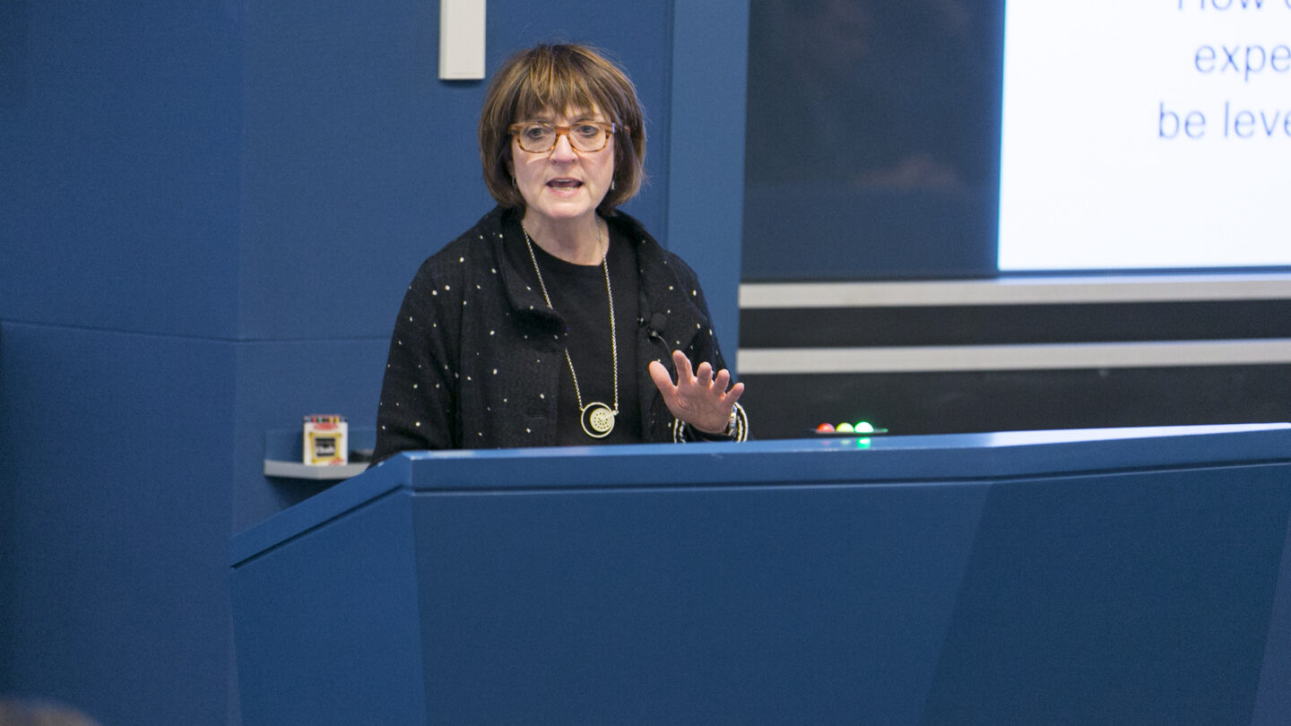 Woman talking behind a lectern