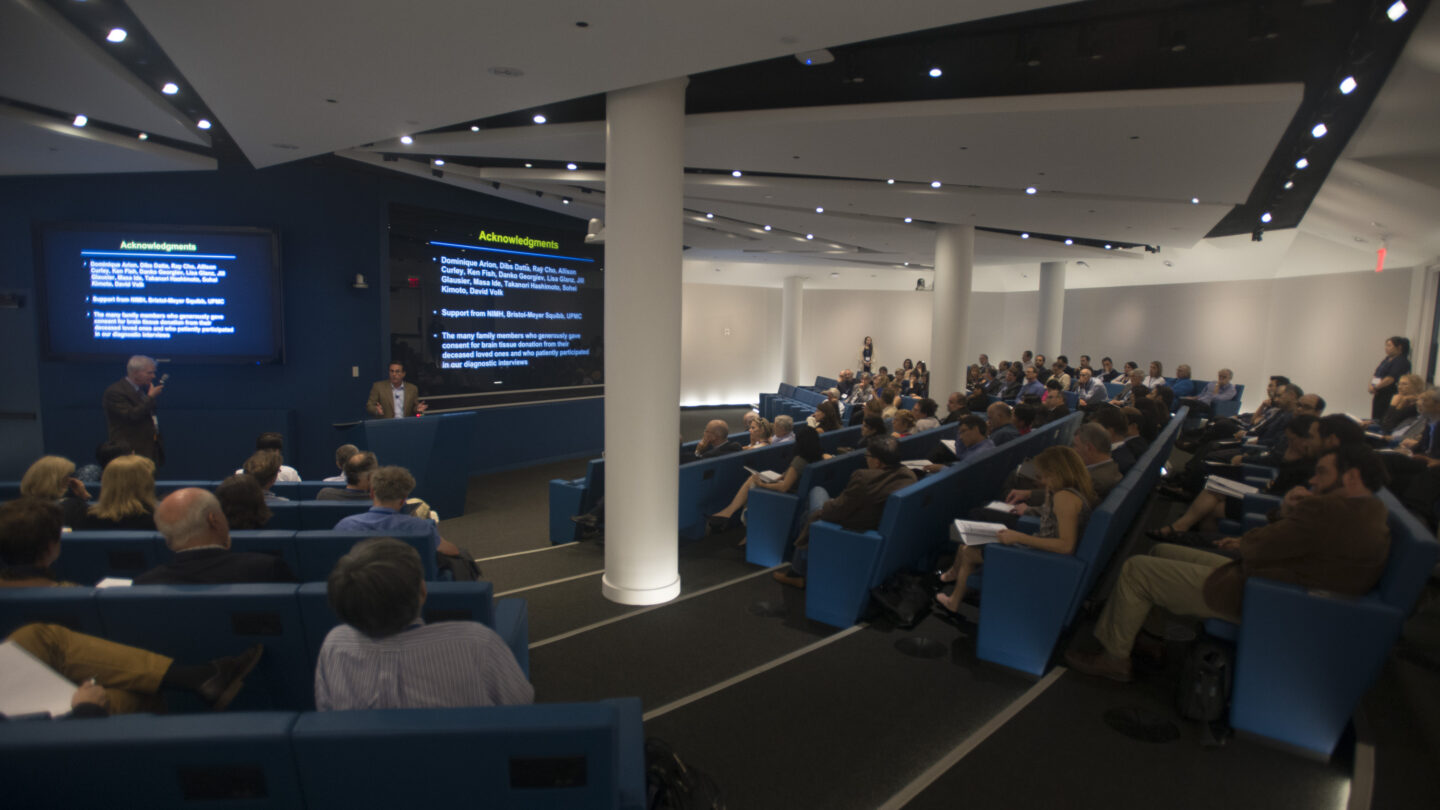 Lecture hall of people watch someone in the front