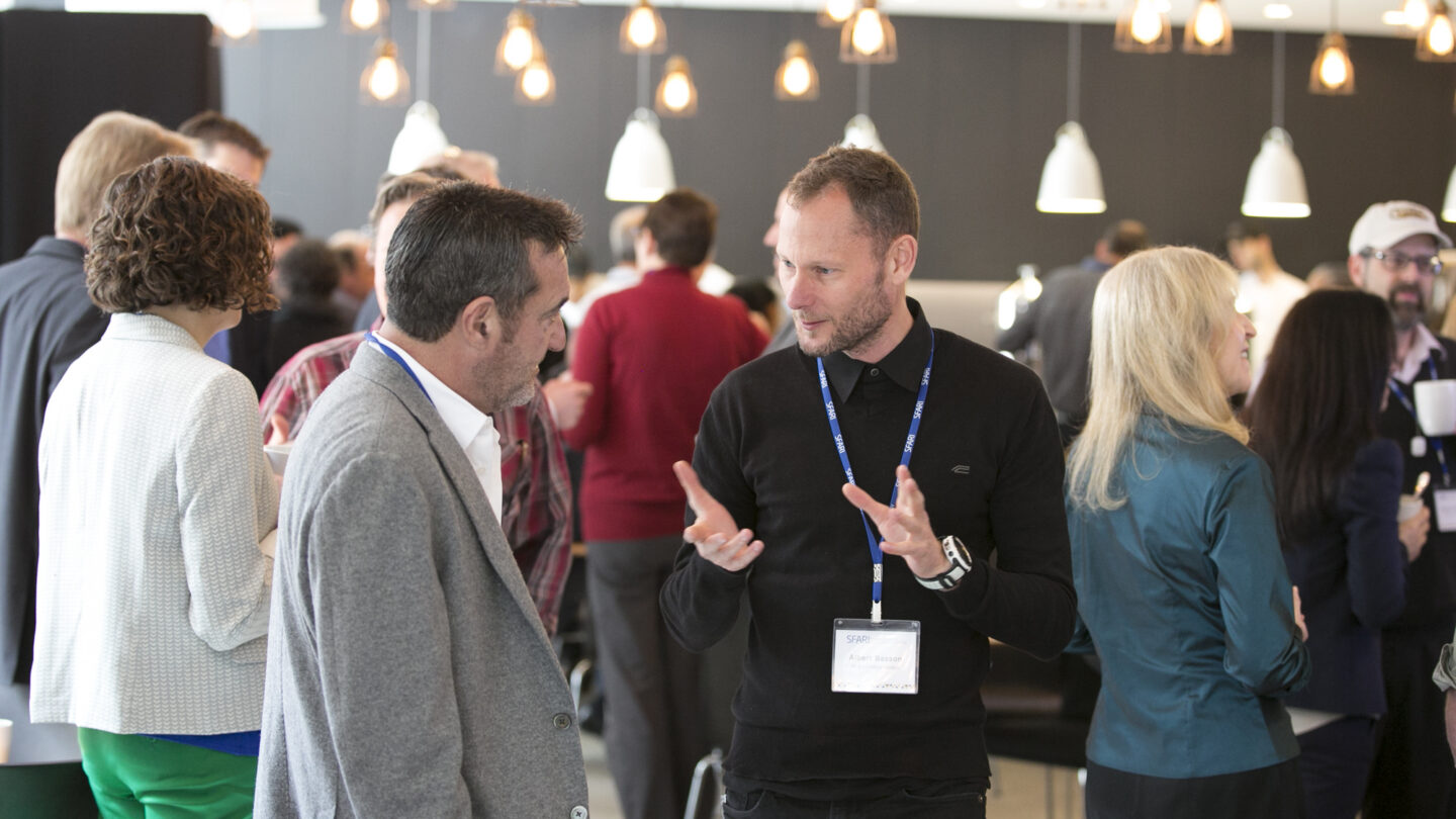 Two men standing and talking