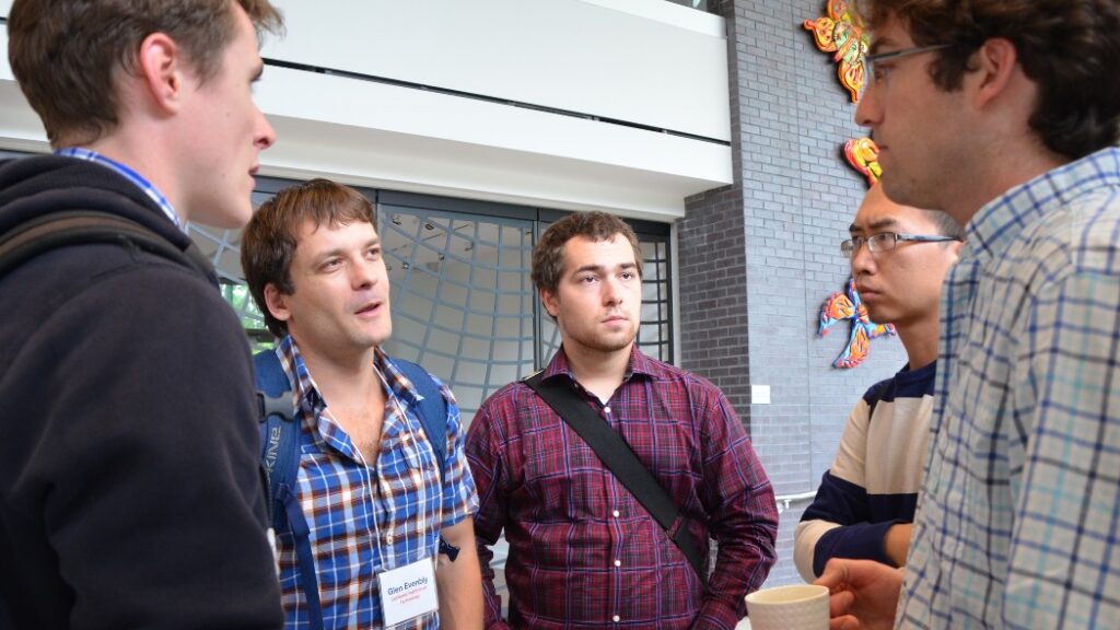 Five people standing and talking