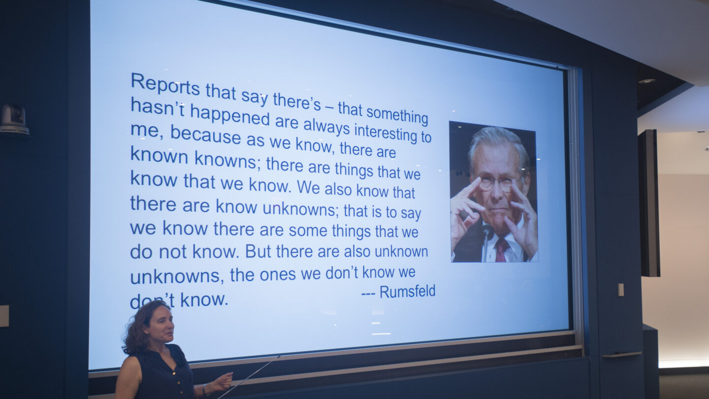 Woman presenting a slideshow that says: 
