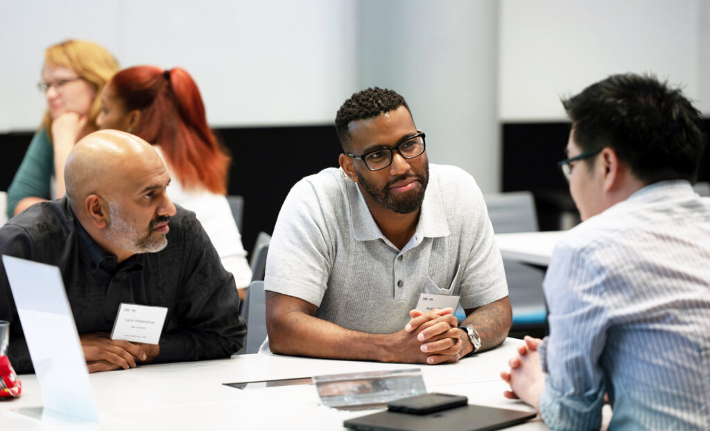 Scientists in a discussion at a table.