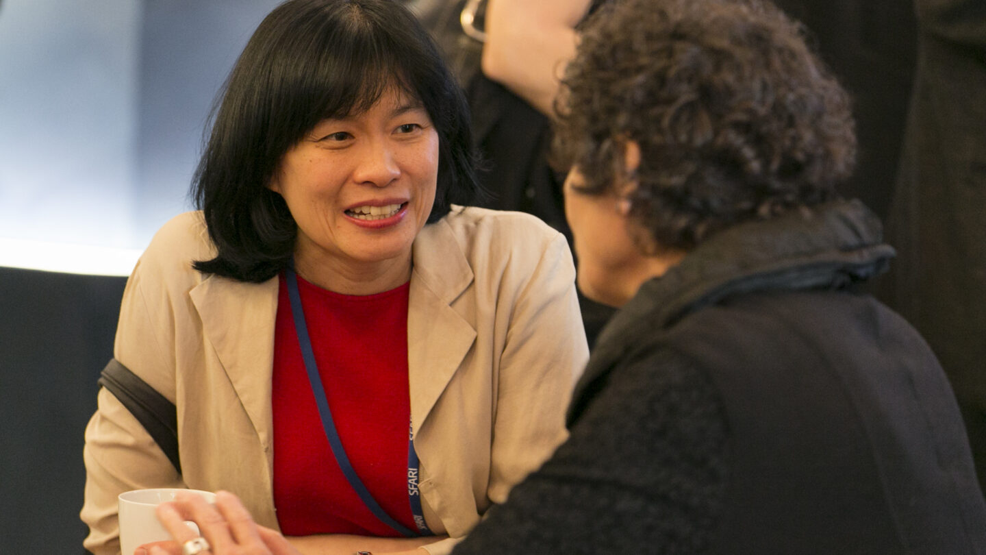 Two people sitting at a table and talking