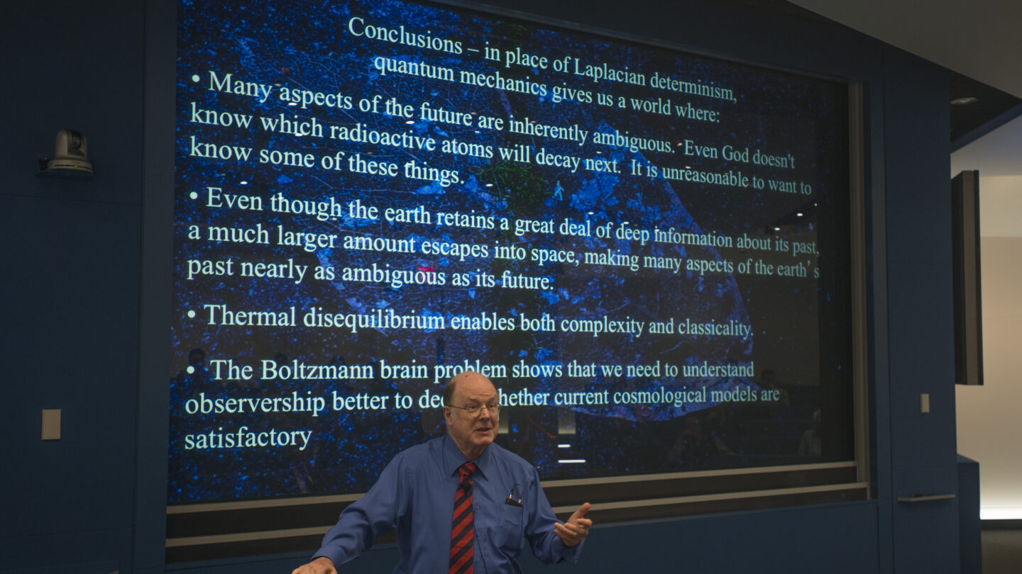 Man standing in front of a slideshow that says 