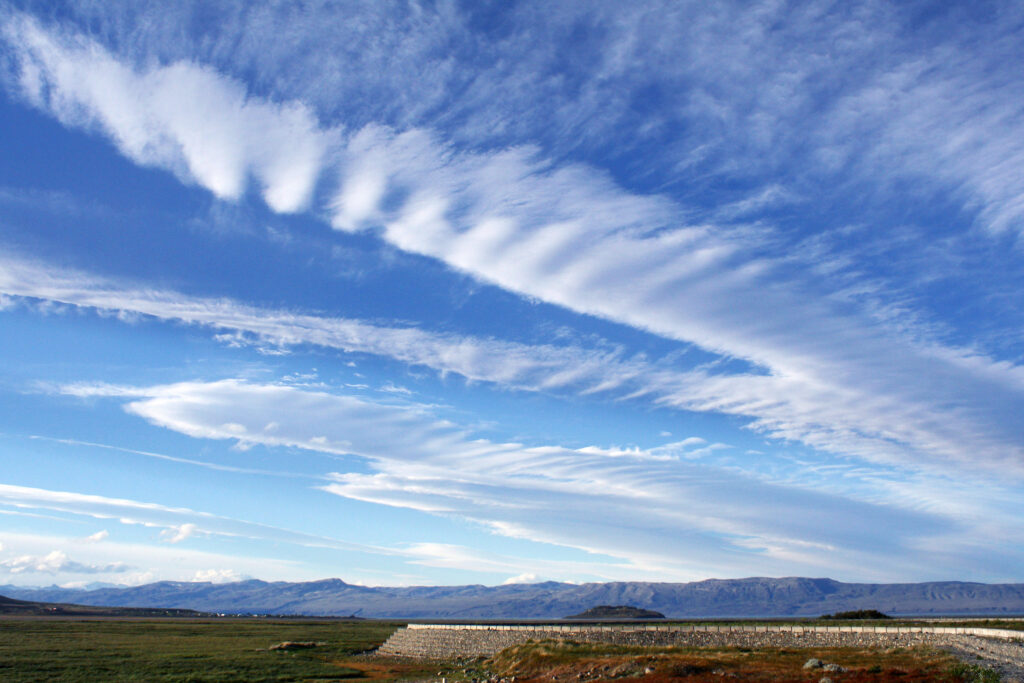 Thin wispy cirrus clouds float in the sky.