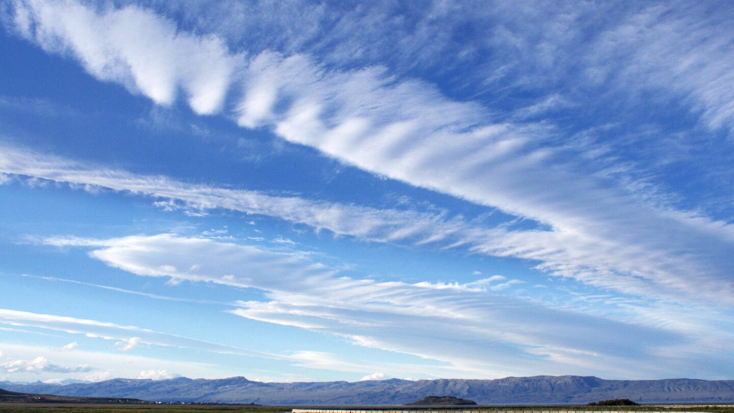 Thin wispy cirrus clouds float in the sky.