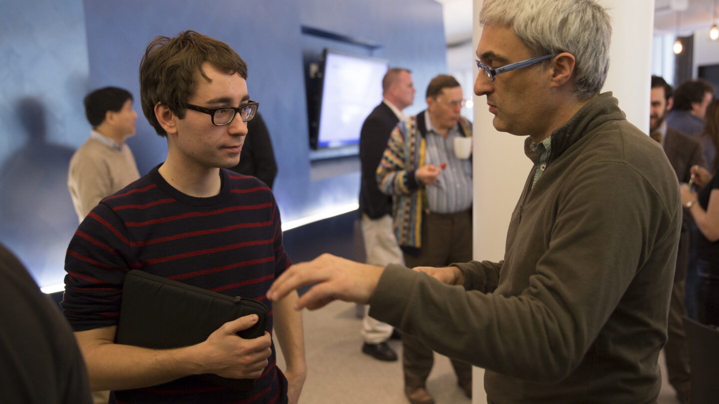 Two men standing and talking