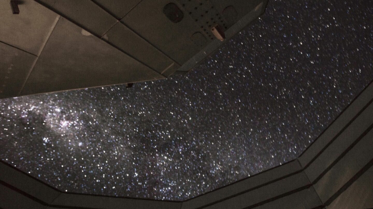 Open Simons Observatory roof, revealing starry sky