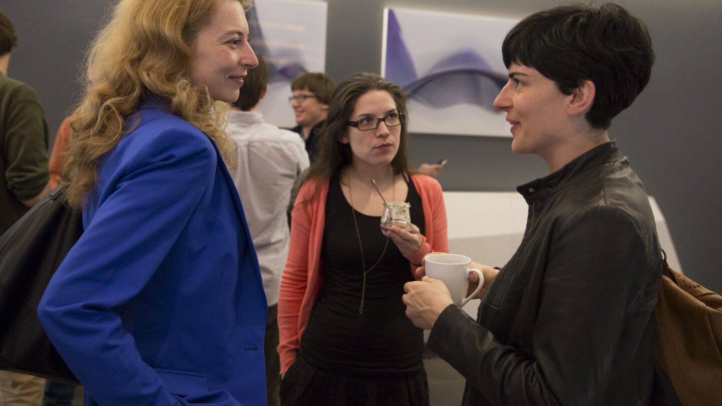 Three women standing and talking