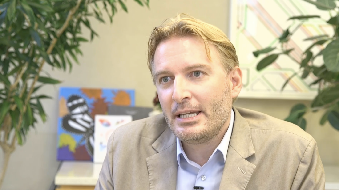 A screenshot of Andrea Alù talking.
