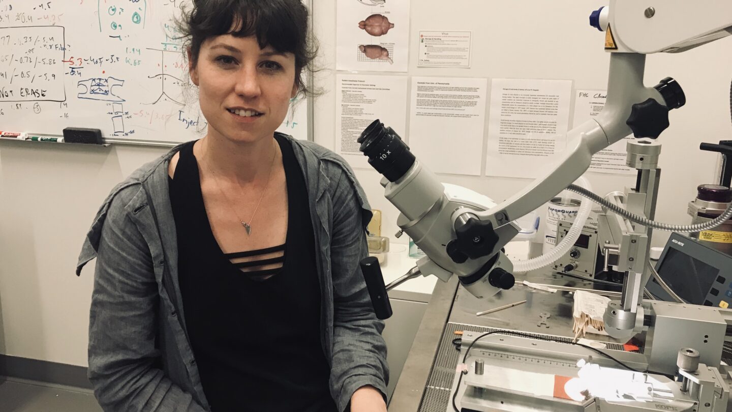 Annegret L. Falkner in front of a microscope