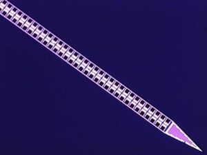 A stylized, purple pencil with a checkered pattern along its body is positioned diagonally on a dark blue background.