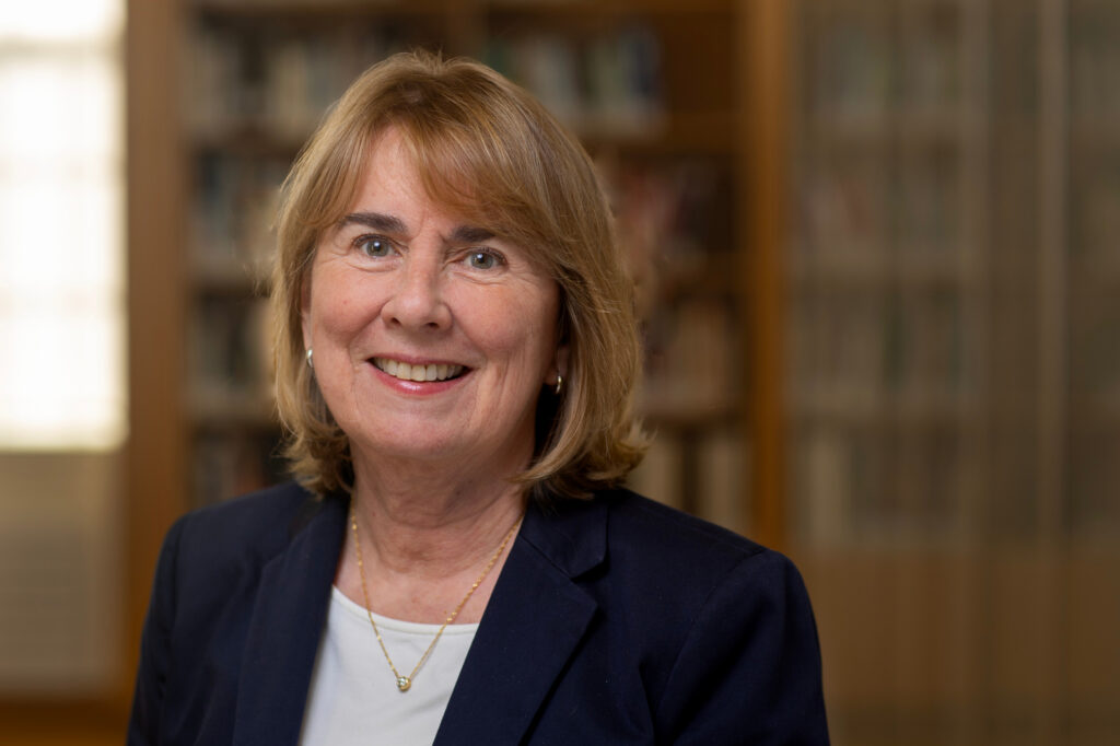 A portrait photo of Jill Pipher in front of bookshelves.