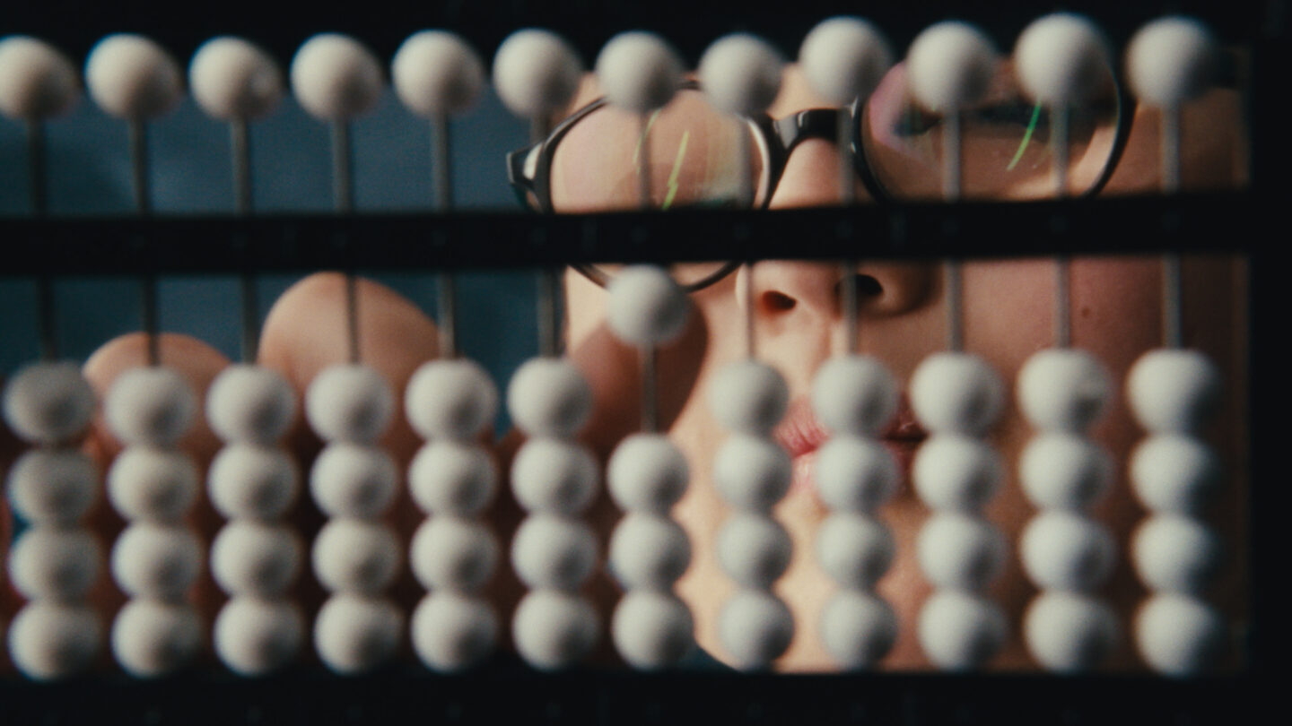 A photograph showing the white beads of the abacus that is used in the Abacus Bee.