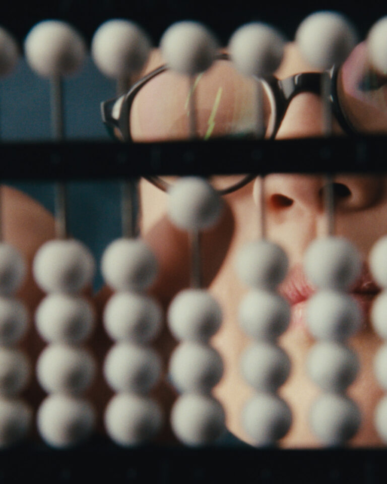 A photograph showing the white beads of the abacus that is used in the Abacus Bee.