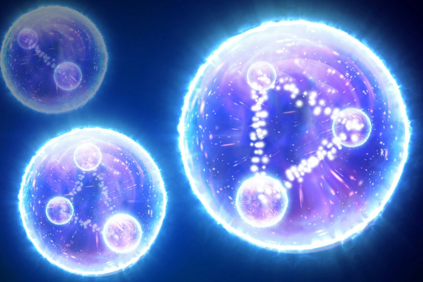 A digital illustration of three spherical objects. Two of the objects have each within them three smaller spheres arranged in a triangular shape and connected by lines made up of smaller orbs. One of the objects has two smaller spheres connected by a line of smaller orbs. All of the objects appear to be glowing and have within them a galaxy-like design.