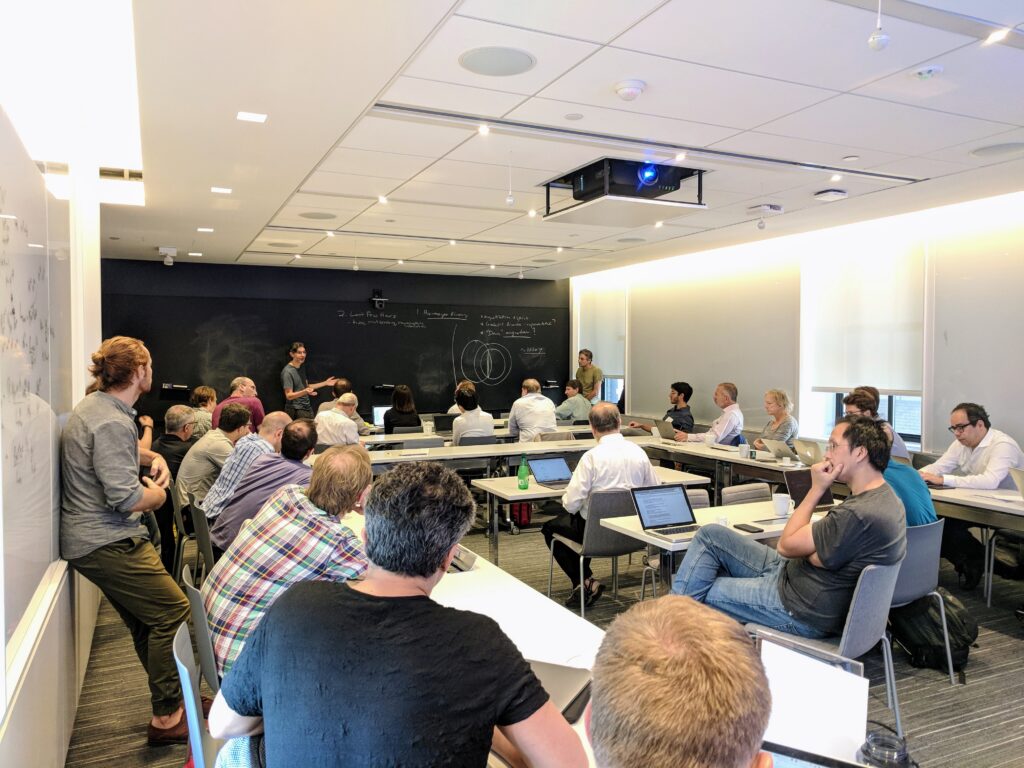 Astrophysicists Yuri Levin and Eliot Quataert lead a discussion during a meeting on the plasma physics of neutron star mergers