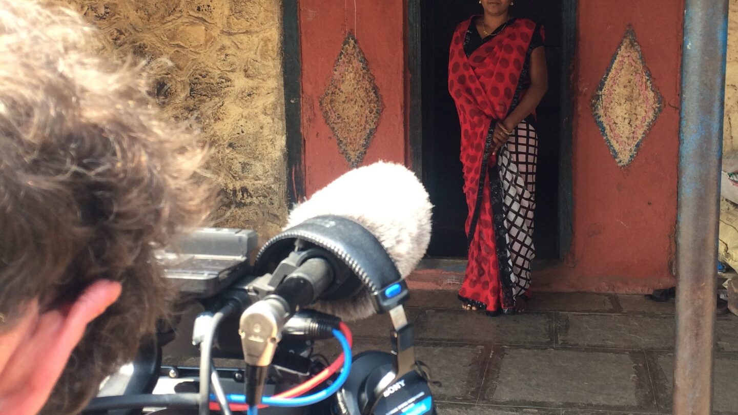 A Vice videographer filming Pooja standing outside her house in Pune, India