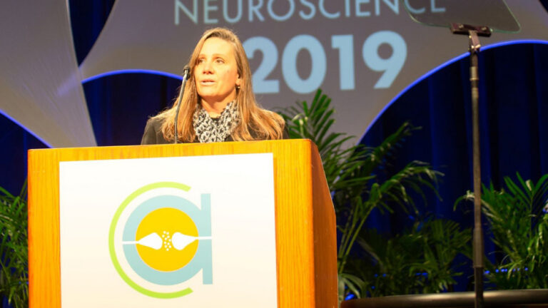Jennifer Raymond standing on the roster at SFN 2019
