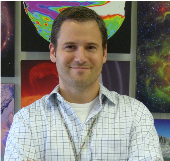 Joel Hurowitz in front of galactic art