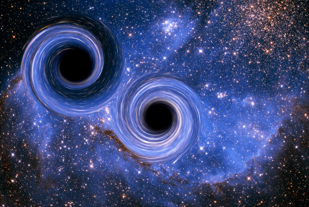 Two black holes with glowing blue rings swirl near each other against a vibrant background of stars and cosmic dust in deep space.