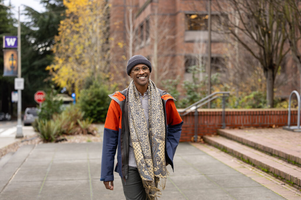 Portrait of smiling Sama Ahmed walking outside the University of Washington.