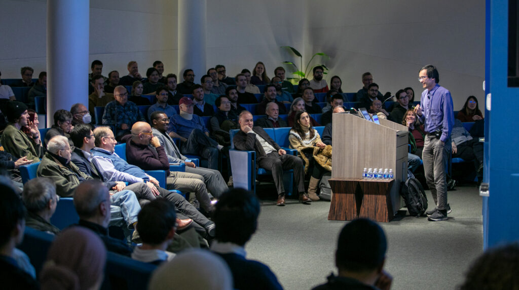 Photo of Terence Tao giving a Presidential Lecture in February 2025 to an engaged audience at the Simons Foundation.