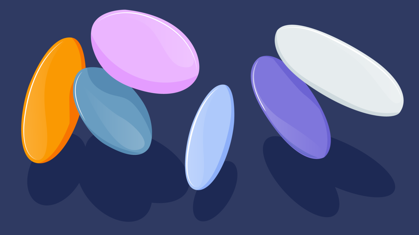 Six large, shiny, oval-shaped pills in orange, pink, blue, light blue, purple, and white on a dark blue background, each casting a shadow.