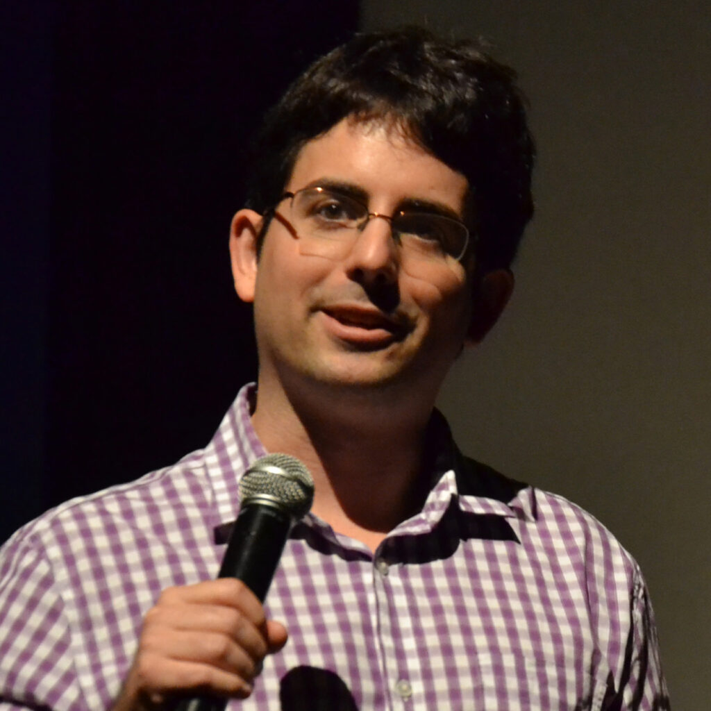 Matt McQuinn speaking into a microphone