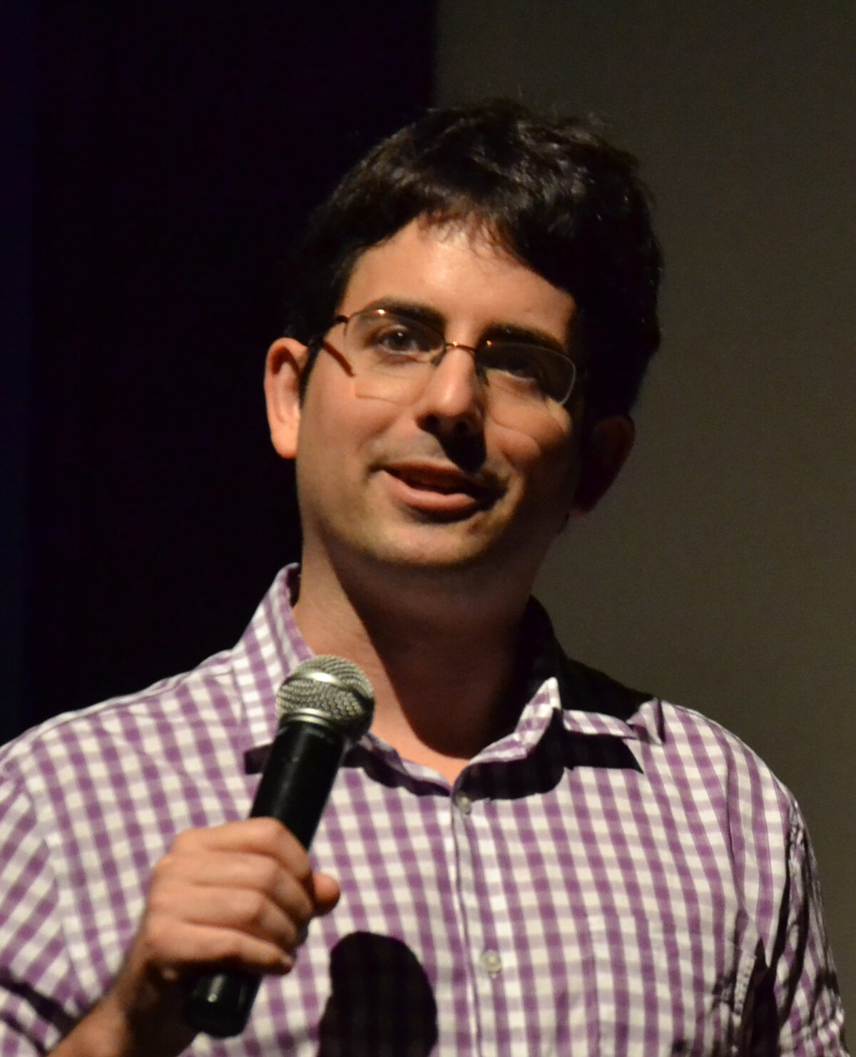 Matt McQuinn speaking into a microphone