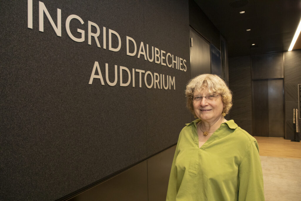 Ingrid Daubechies standing in front of Flatiron Institute auditorium