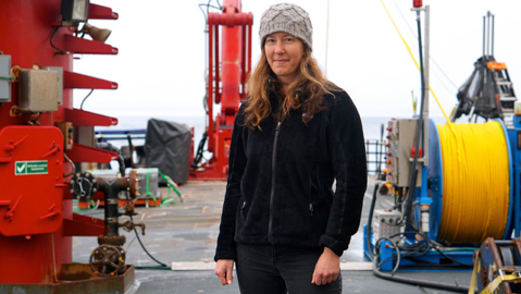 Laurie Juranek in front of a lot of water machinery