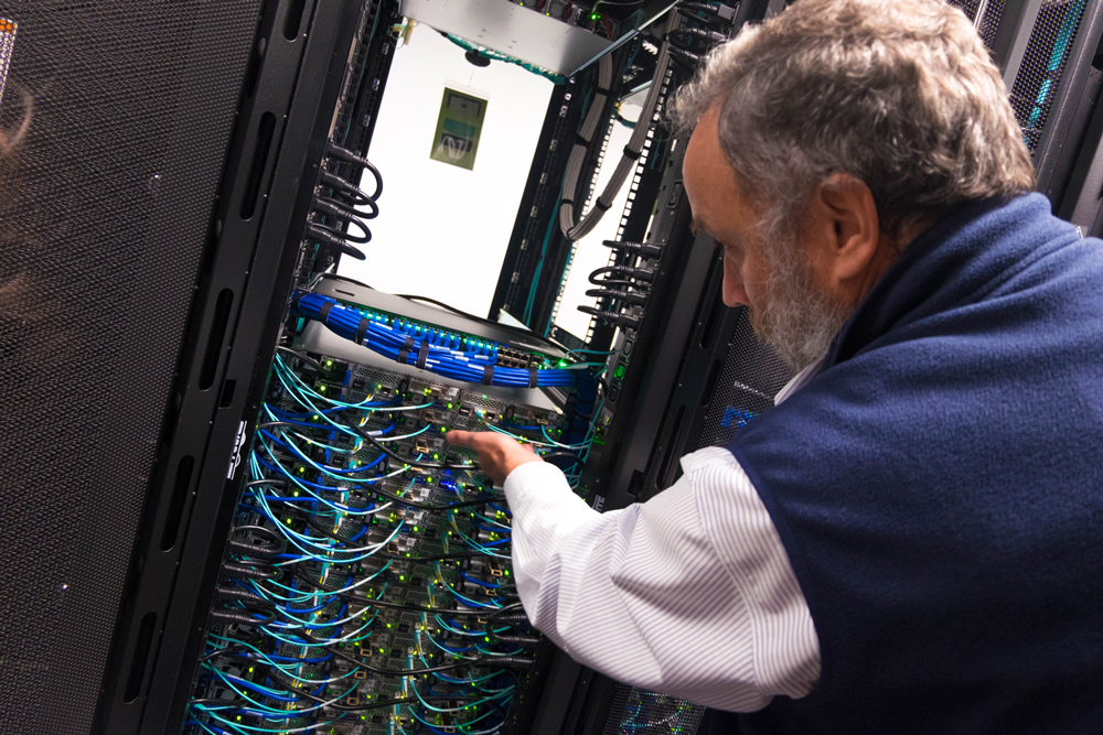 Back view of Nick Carriero, pointing at wires