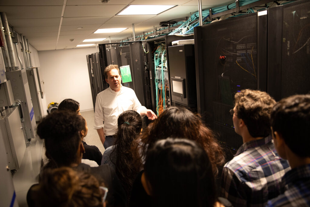 Ian Fisk, co-director of the Scientific Computing Core, leads students on a tour of the Flatiron Institute’s high-performance computing cluster