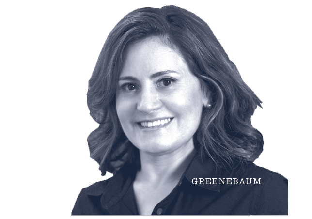 A woman with shoulder-length wavy hair smiling, wearing a collared shirt. The word GREENEBAUM appears near her shoulder. The image has a blue-gray tint and a plain light background.