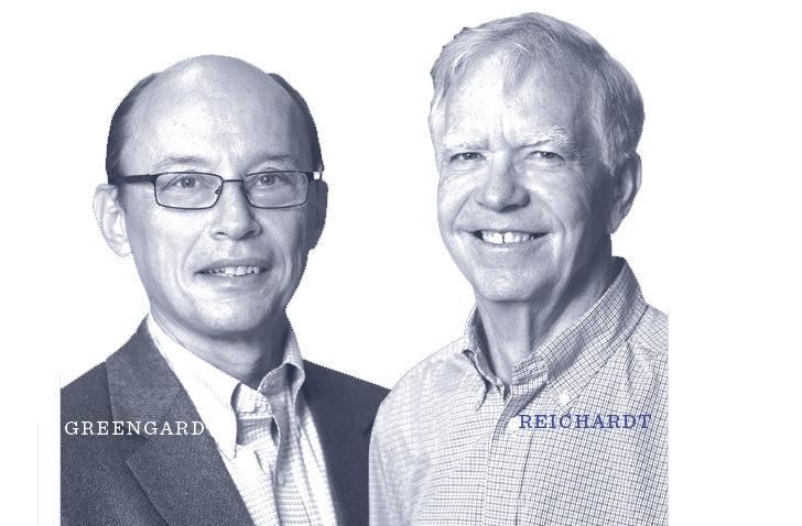 Two older men stand side by side, both smiling. One wears glasses and a suit jacket; the other is in a light-colored, collared shirt. The names GREENGARD and REICHARDT are written near them.