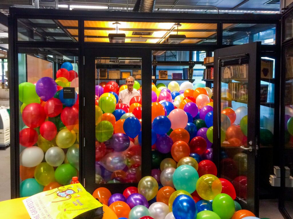 Krishna Shenoy surrounded by balloons