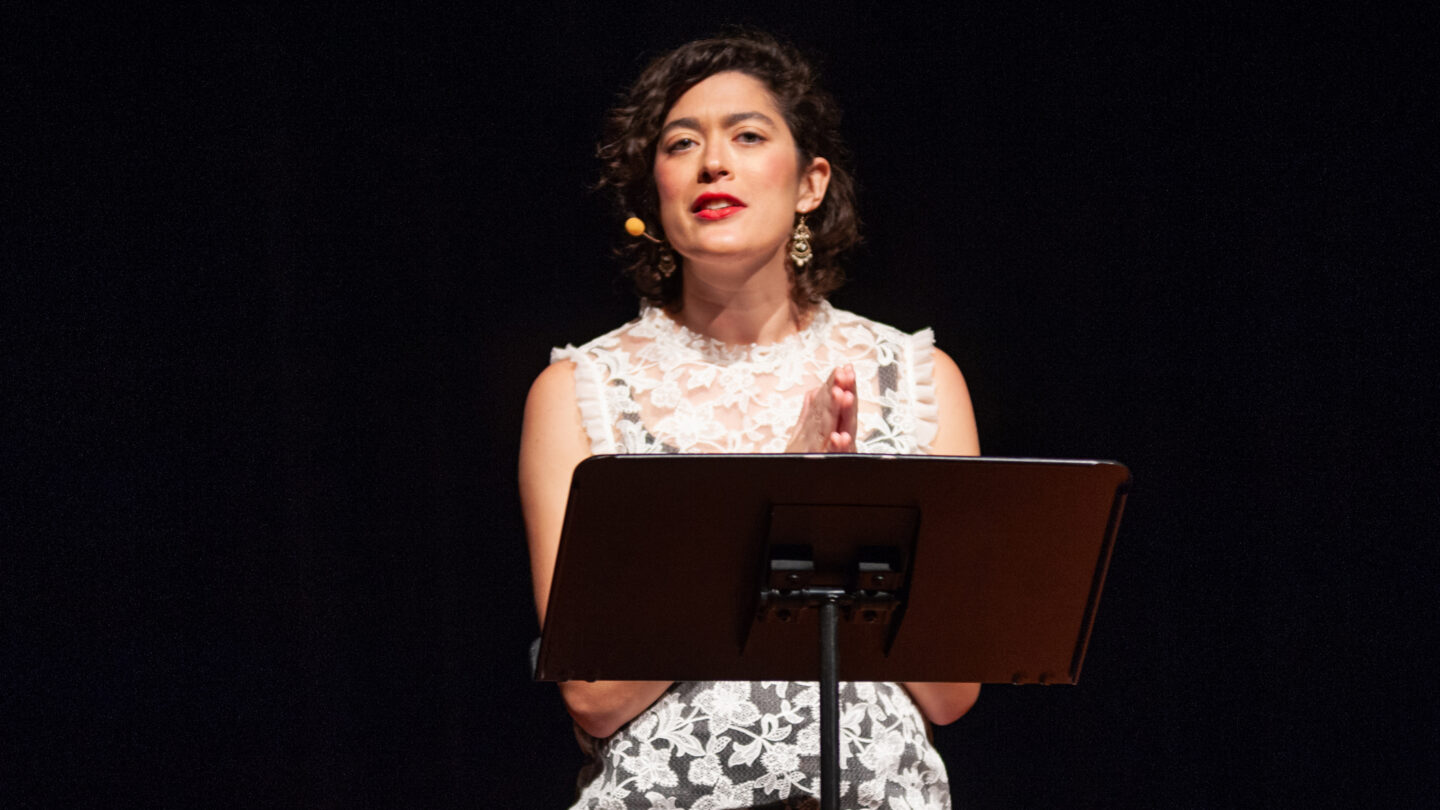 Woman standing behind music stand at Radiolab's 
