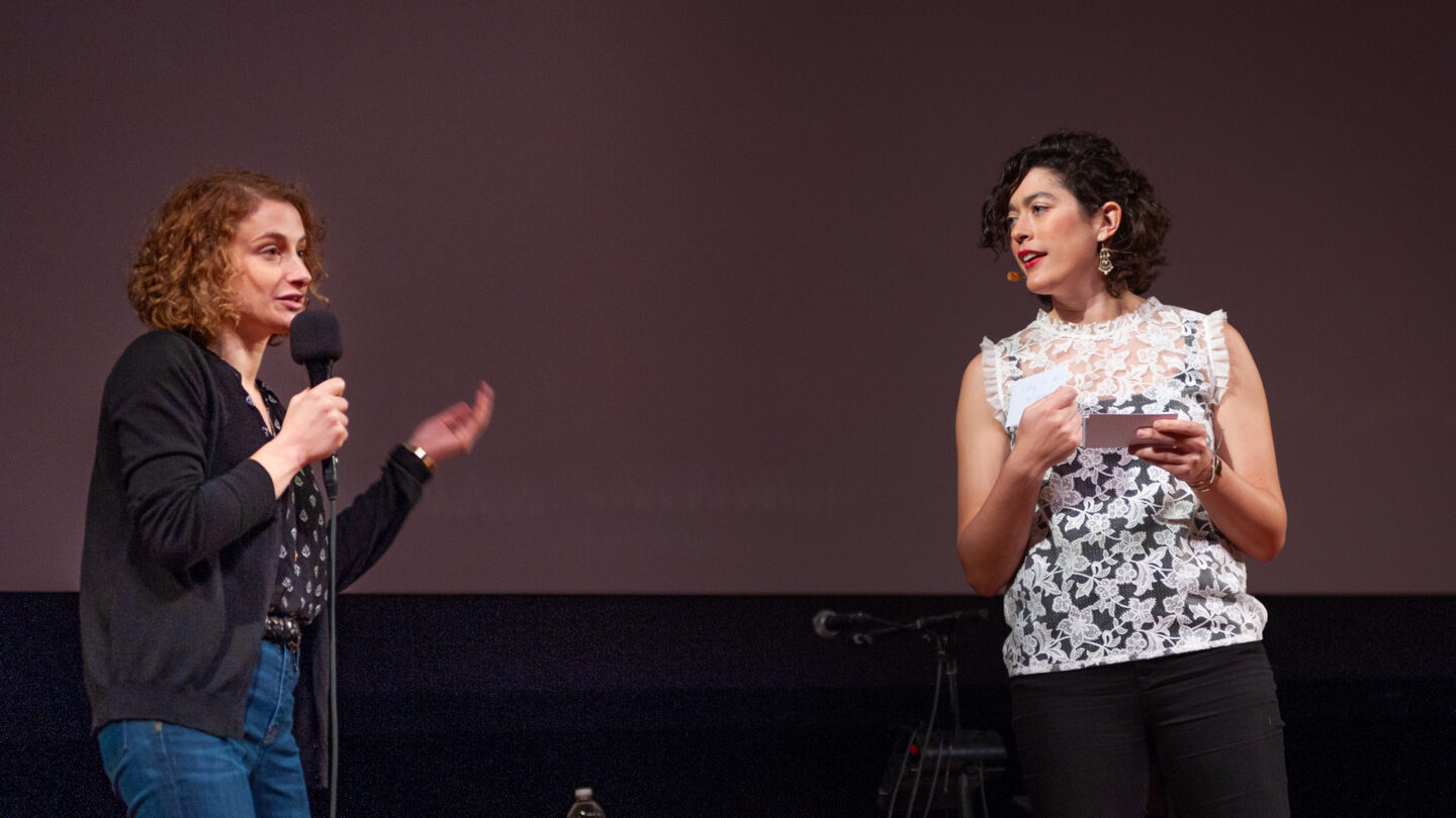 Two women standing on stage at Radiolab's 