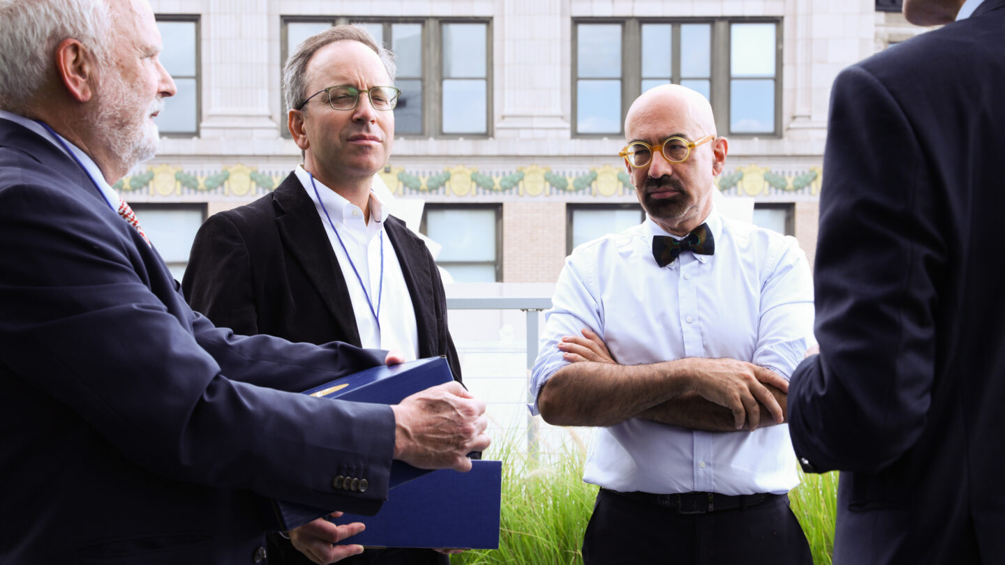 A photograph of four men in an outdoor space.