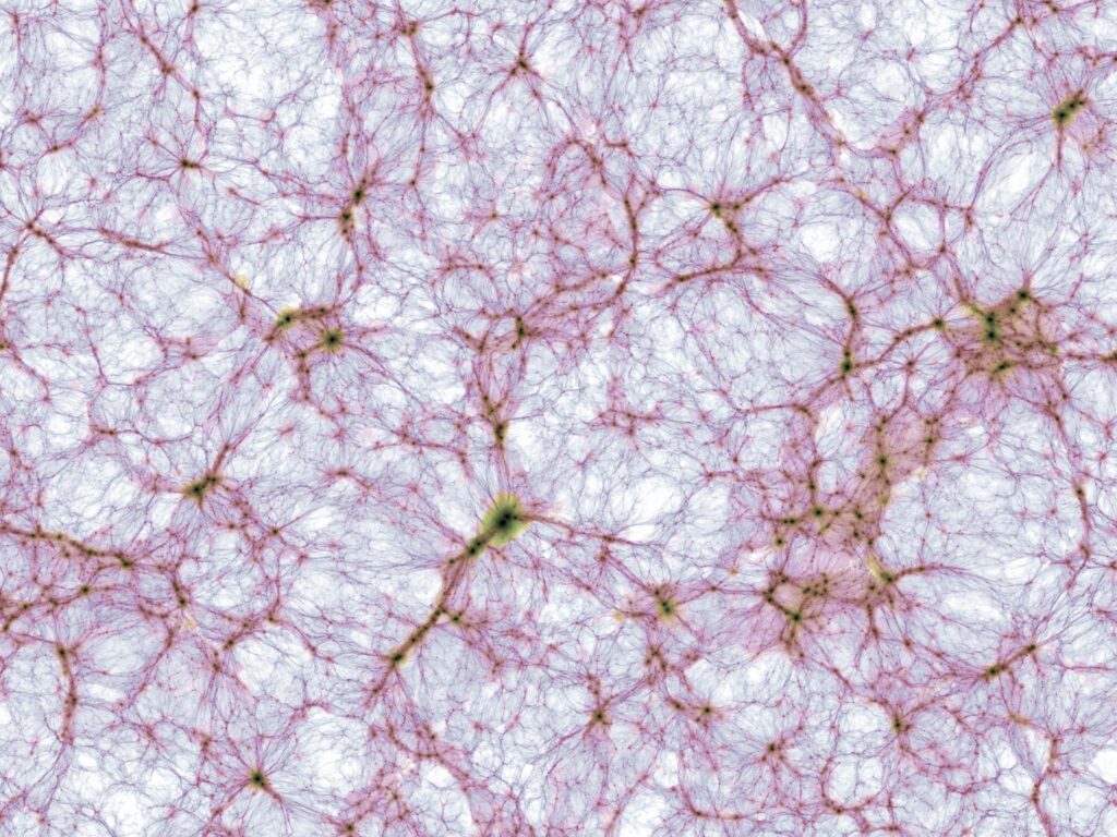 Thin slice through the cosmic large-scale structure in the largest simulation of the IllustrisTNG project. The image brightness indicates the mass density and colour visualizes the mean gas temperature of ordinary (“baryonic”) matter. The displayed region extends by about 1.2 billion lightyears from left to right