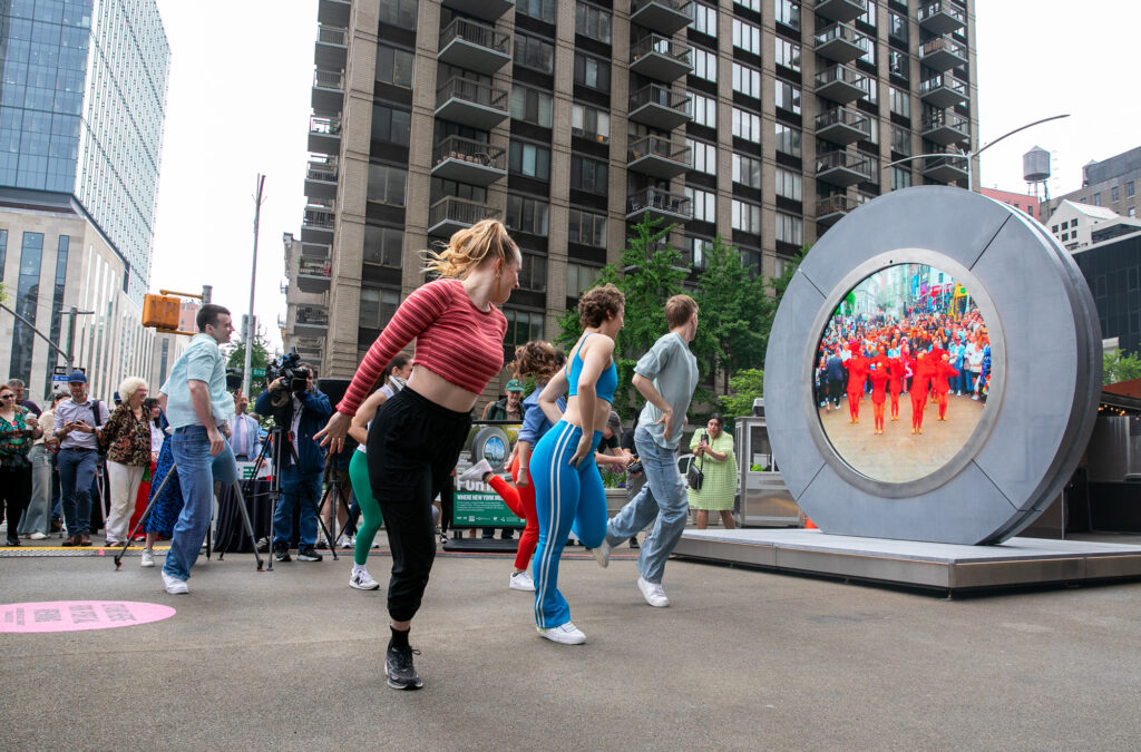 People dancing in front of the Portal in New York City